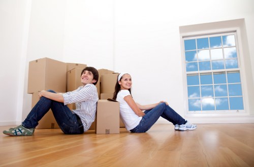 A busy middle stage of a move with furniture and cartons in transit